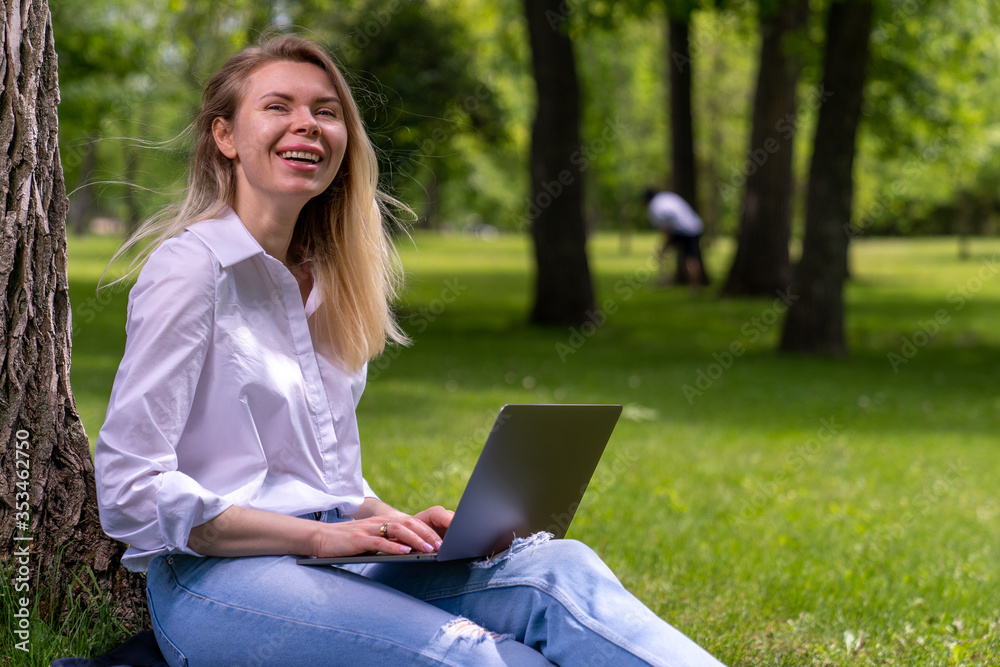 young business woman working online sitting in a park young business woman working online sitting in a park