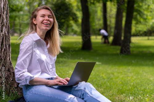 young business woman working online sitting in a park