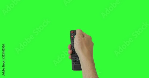 Isolated Male hand with TV remote pressing button turn on or off TV. Green screen. Place for your advertisement. Pack of Gestures. Using a remote control over keyed chroma key background. POV