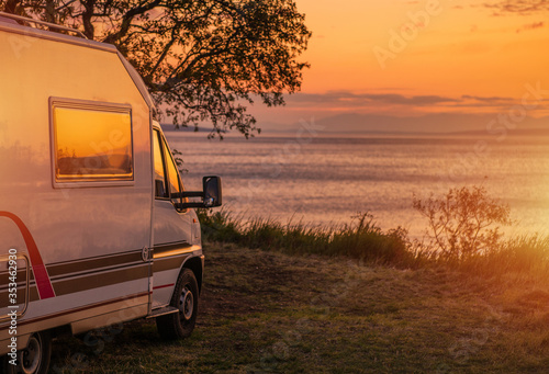 Waterfront RV Camping Site During Scenic Sunset.