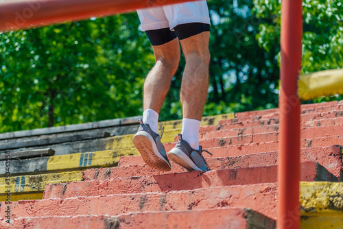 Closeup outdoor image of male athlete shoes walking up the stairs © qunica.com