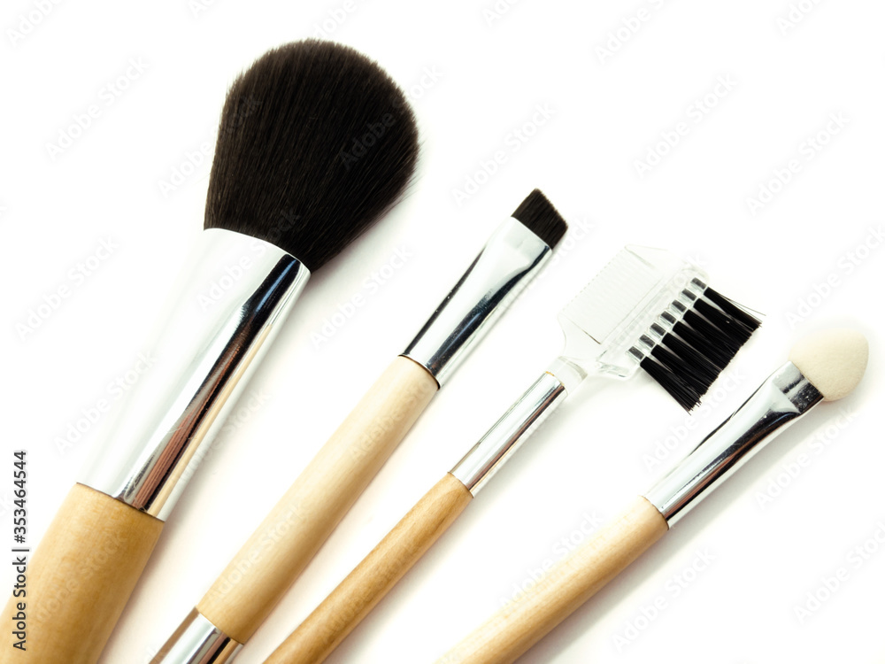 Wooden makeup brushes isolated on white background. Set of powder brush, eye brush, lip brush and eyebrow brush. Makeup set. Female accessories. Wooden makeup brushes isolated on white background. Set of powder brush, eye brush, lip brush and eyebrow brush. Makeup set. Female accessories.