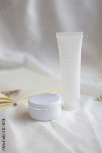 White jar of cream on white fabric background. beauty and cosmetic product  mock up 
