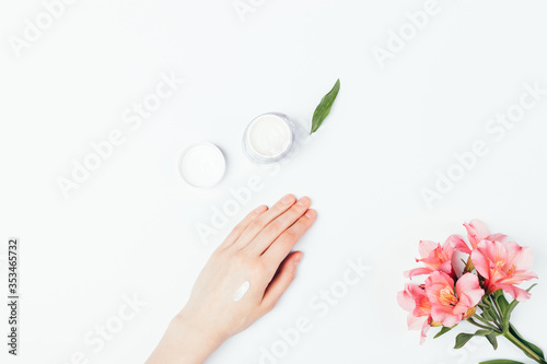 Top view female hand with applied sample of cosmetic skin care cream