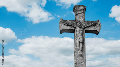 Unique very old and ancient stone partially destroyed statue: the crucifixion of Jesus Christ. Free copy space for design.