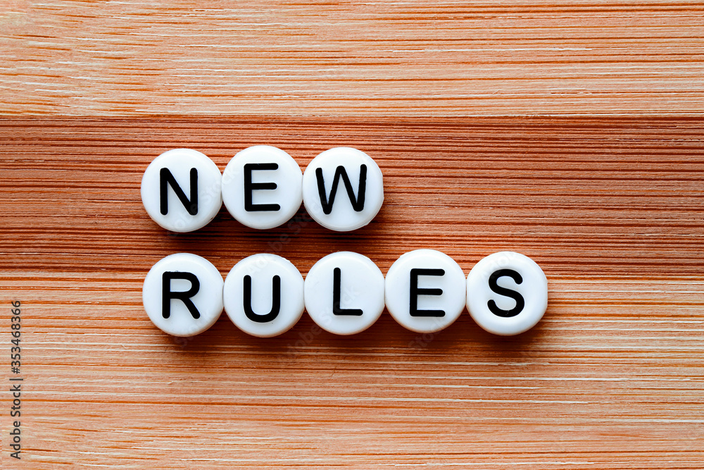 New Rules text on a wooden table New Rules text on a wooden table