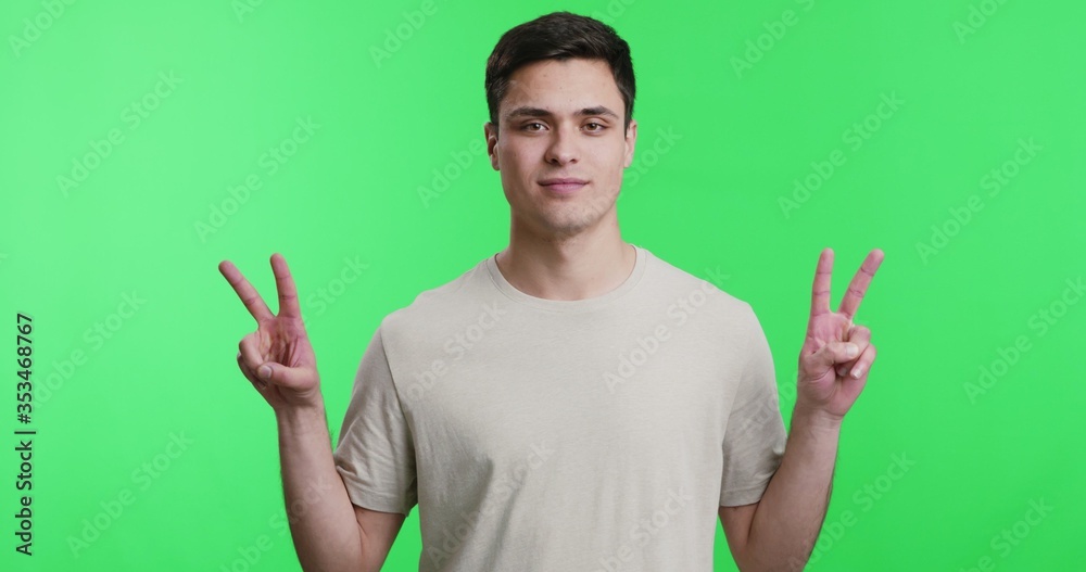 Cheerful man showing double v sign, peace gesture Cheerful man showing double v sign, peace gesture