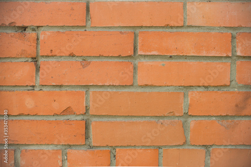 Orange bricks wall close up background. Stained old brick wall texture.