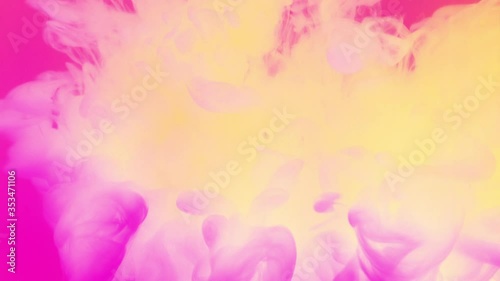 Soft yellow fluid ink pouring in pink liquid. Abstract background. photo