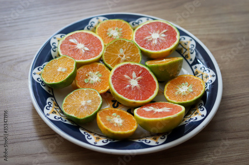 Beautiful lemons  bergamots and grapefruits cut in half on a cutting board.