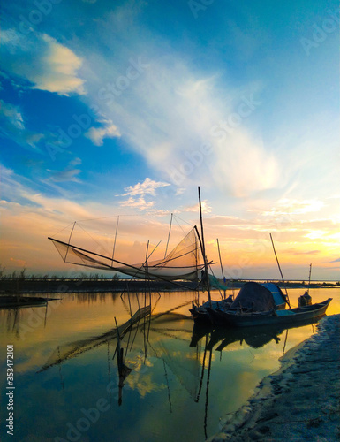 Fishing net with boats during Sunset at the river Brahmaputra in Majuli Island, Assam.