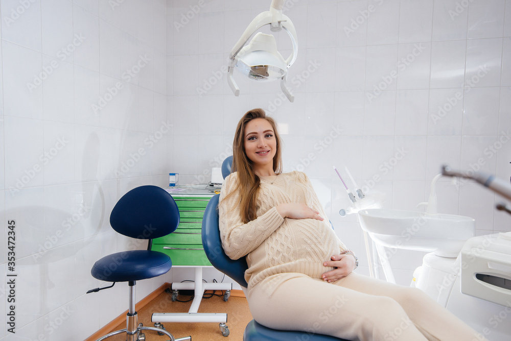 A professional dentist treats and examines the oral cavity of a pregnant girl in a modern dental office. Dentistry A professional dentist treats and examines the oral cavity of a pregnant girl in a modern dental office. Dentistry