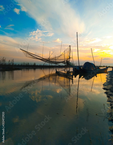 Fishing net with boats during Sunset at the river Brahmaputra in Majuli Island, Assam.