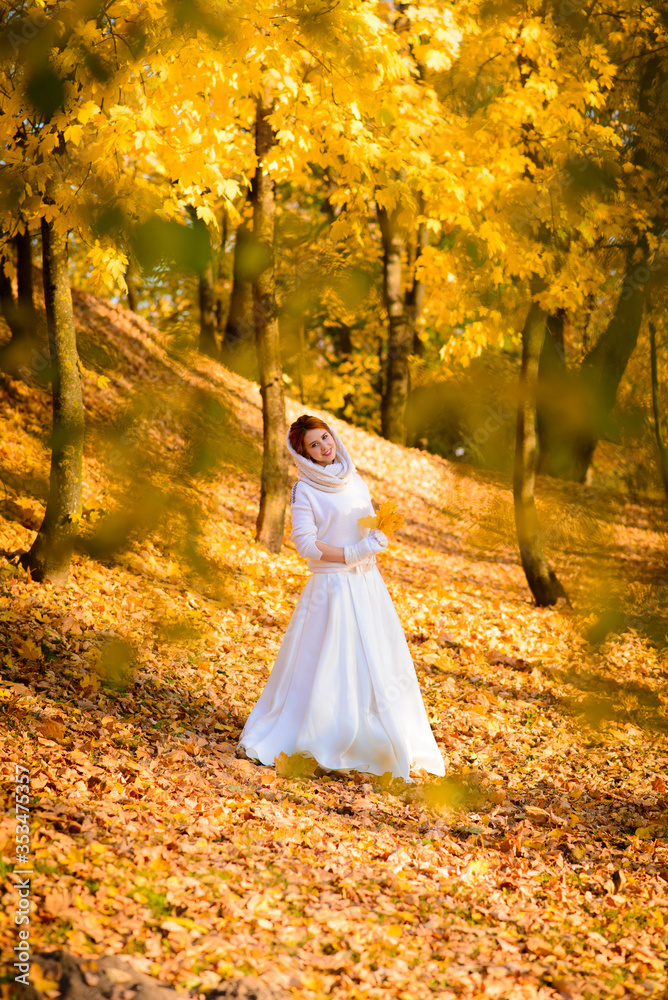 Young woman in a autumn park. Lady with a leafs.