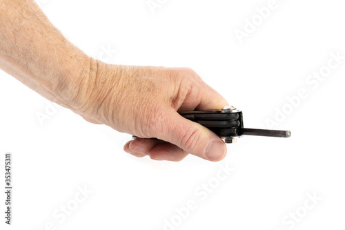 a male hand holding a folding set of hex keys ready to tghten a screw isolated on white