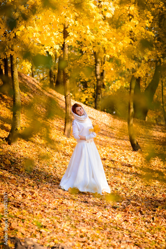 Young woman in a autumn park. Lady with a leafs.