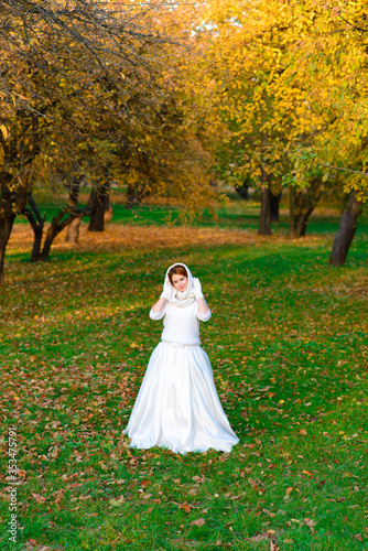 Young woman in a autumn park. Lady with a leafs.