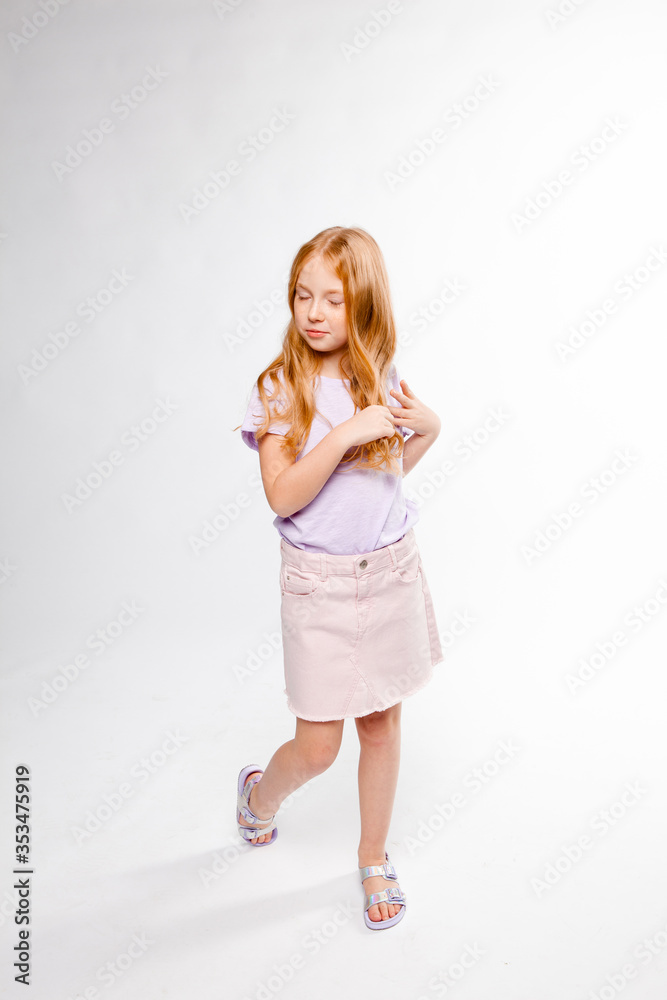 cute red-haired long-haired girl in daily clothes (skirt, T-shirt) braids her hair cute red-haired long-haired girl in daily clothes (skirt, T-shirt) braids her hair