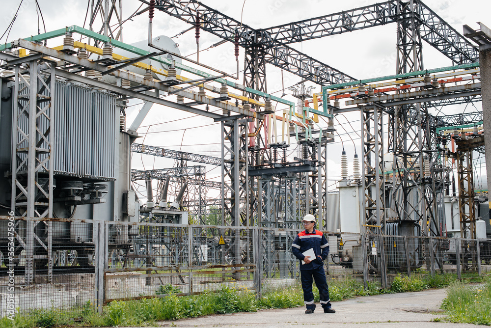 The energy engineer inspects the equipment of the substation. Power engineering. Industry The energy engineer inspects the equipment of the substation. Power engineering. Industry
