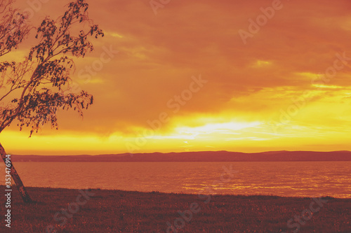 Nature landscape. Embankment of the lake in the evening with a dramatic sky. Sunset over lake Balaton, Hungary, Europe