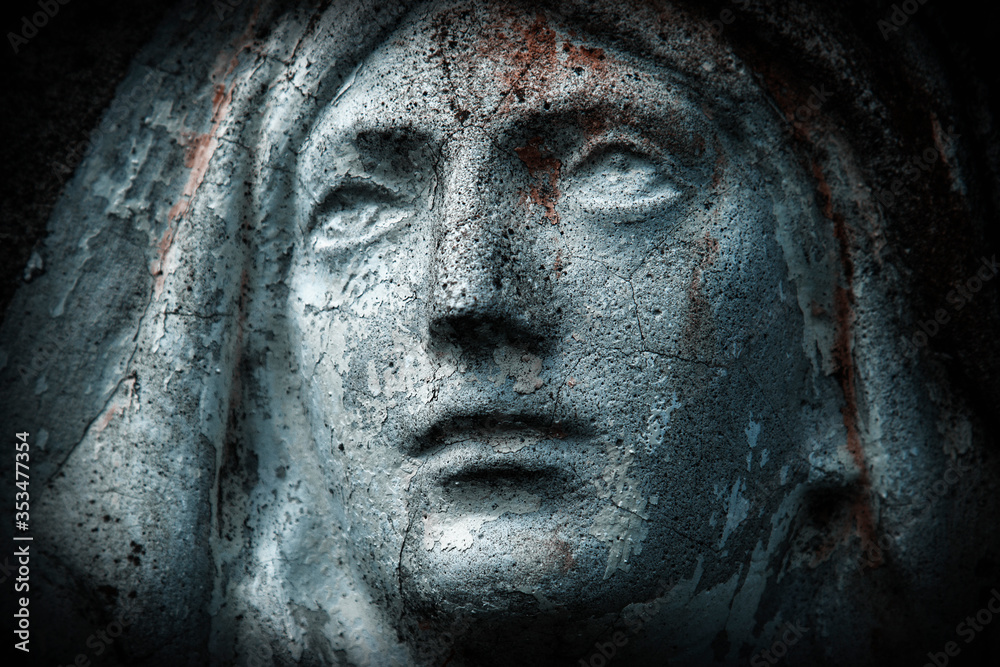 Close up ancient statue with cracks: Virgin Mary. Horizontal image.