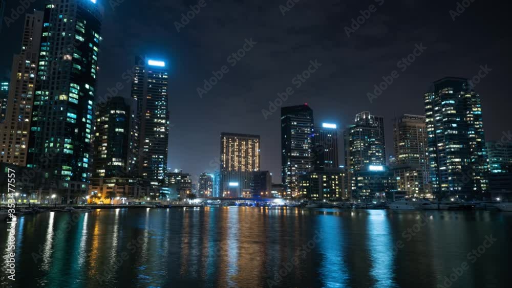 night time-lapse, big city, skyscrapers with reflection on water, canal view. Dubai UAE night time-lapse, big city, skyscrapers with reflection on water, canal view. Dubai UAE