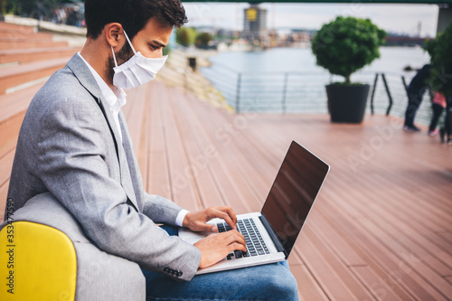 Young man wearing a face mask working outside