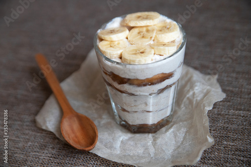 Homemade tiramisu without sugar with a banana and a wooden spoon. Healthy eating. Home cooking. We cook in self-isolation. Diet. Low in calories.