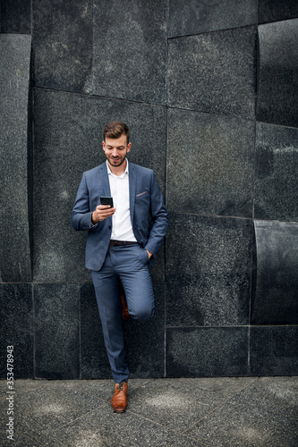 Stylish businessman using smartphone