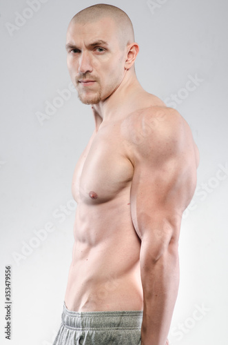 Sexy athlete posing on a white background Topless. Fitness