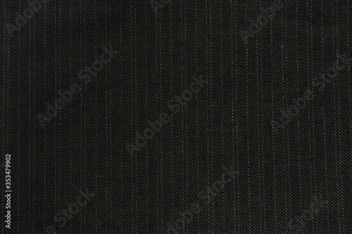 Denim jeans cloth frame in trendy dark grey color. Black jeans fabric texture. Dark pinstripe jeans fabric, background