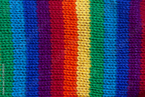 A knitted wool fabric in the colors of the rainbow. Fun background. Vertical strip