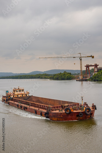 Borim,Goa/India- May 1 2020: Barges carrying mining ore for export at Borim, Goa. photo