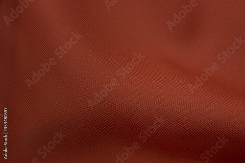 Dark orange polyester background. Stock photo.