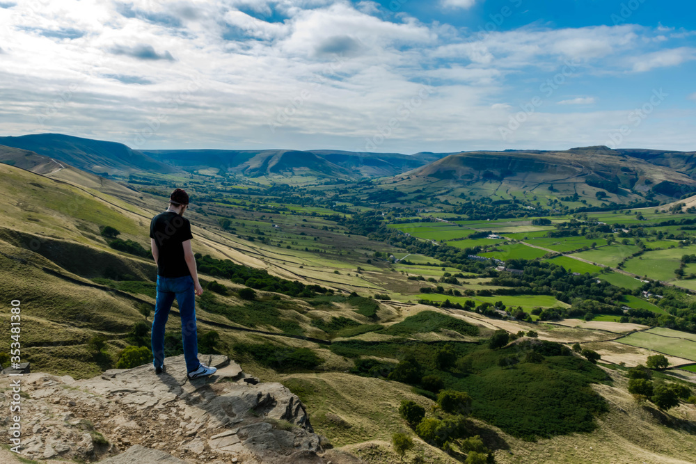 Tourist sitting on the rock, Valley in Peak Distrikt, UK