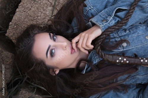 girl with a whip lying on ground cracks