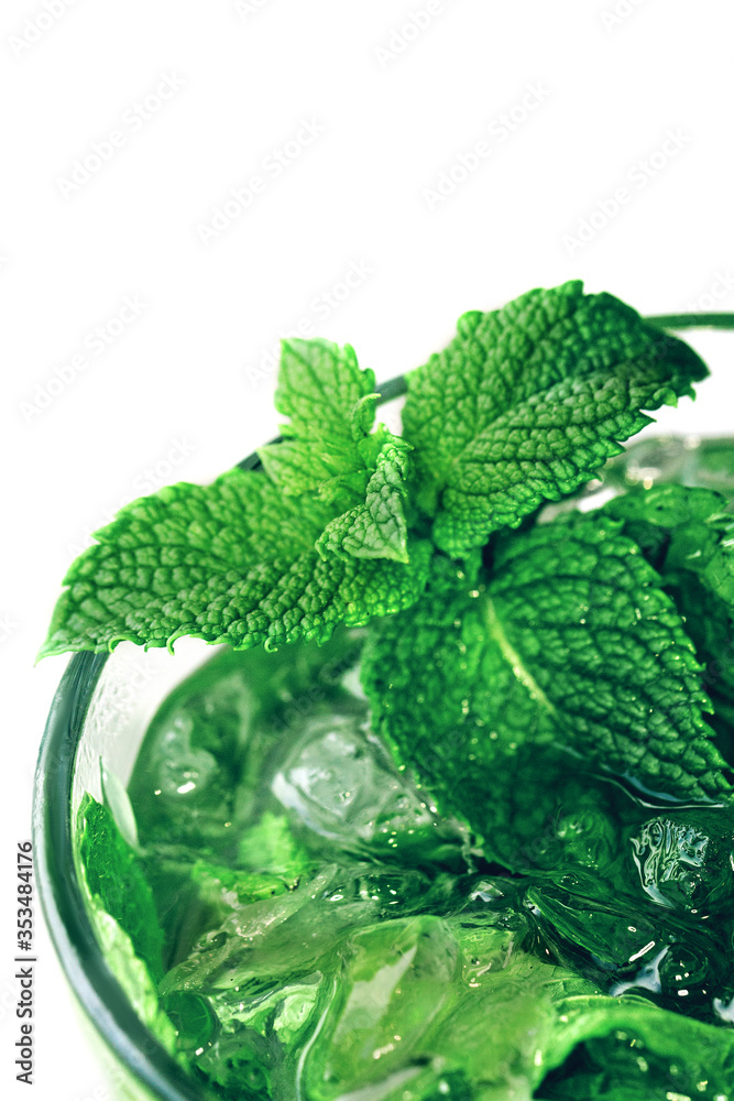 Mojito cocktail. Mint in a cocktail close up macro shot on white background. Cold drink on hot days Mojito cocktail. Mint in a cocktail close up macro shot on white background. Cold drink on hot days