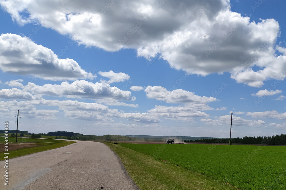 tractor plows a field in spring