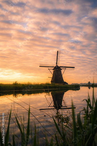 Amazing sunrise of beautiful windmills at Kinderdijk, The Netherlands during sunrise, no tourists due to Covid-19