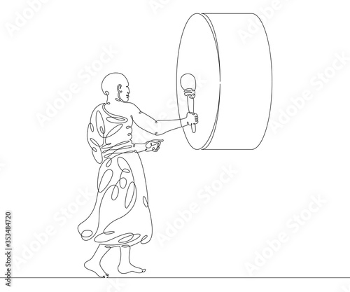 Buddhist monk beats the big drum