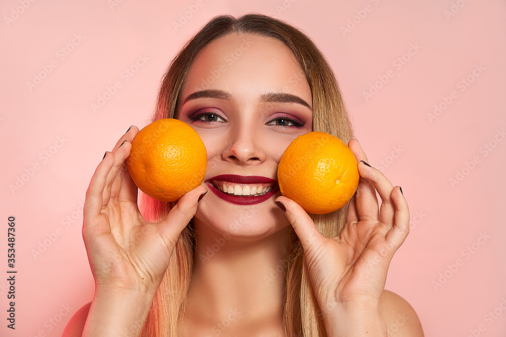 Beautiful girl with orange, isolated on studio background. Cosmetics, food, beauty fashion concept, space for text