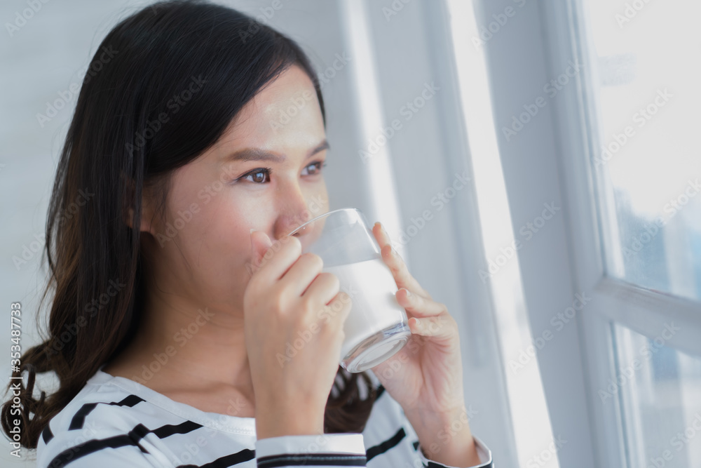Young beauty Asian woman drink milk and smile Young beauty Asian woman drink milk and smile