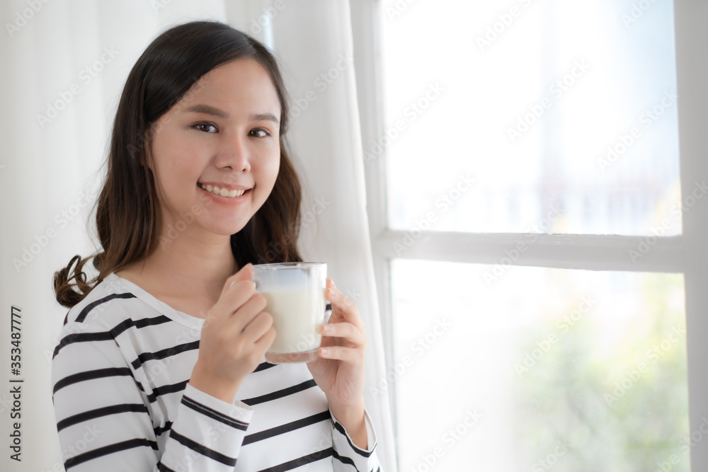 Young beauty Asian woman drink milk and smile Young beauty Asian woman drink milk and smile