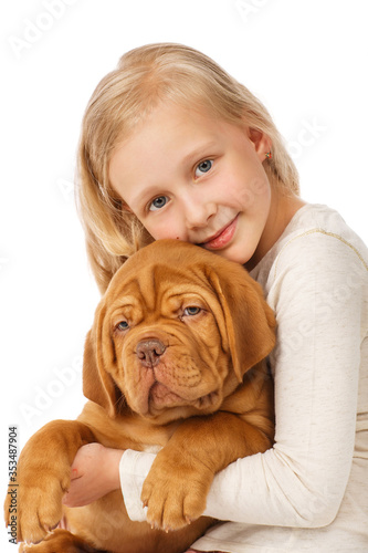 Little girl with a puppy of dogue de Bordeaux