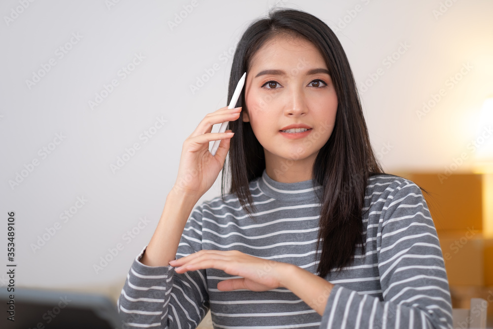 Close up of Asian woman working with tablet and smiling. Close up of Asian woman working with tablet and smiling.