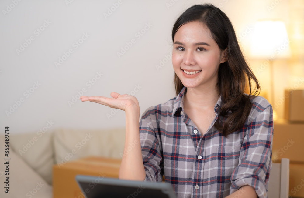 Beauty Asian woman showing smartphone on hand and smiling Beauty Asian woman showing smartphone on hand and smiling