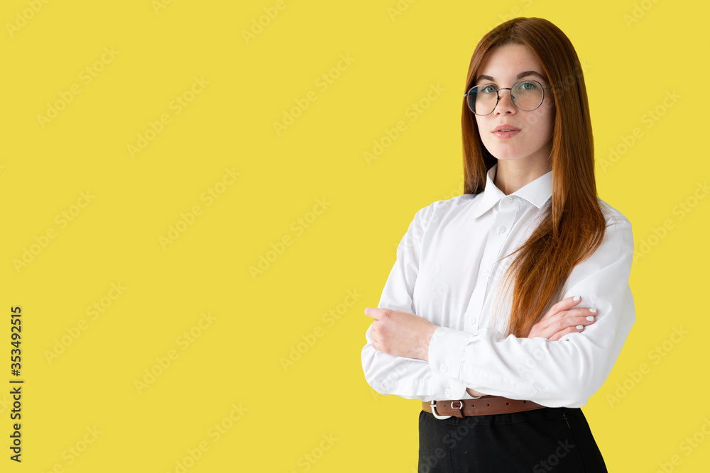 Young girl in white ruble isolated on a yellow wall background studio portrait. People sincere emotions lifestyle concept. Layout copy space. Young girl in white ruble isolated on a yellow wall background studio portrait. People sincere emotions lifestyle concept. Layout copy space.