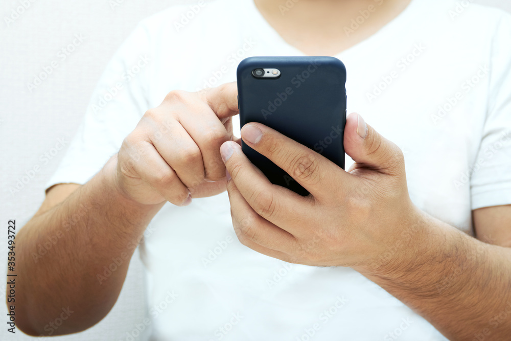 A person is holding a phone and tapping the screen on a white background with copy space. Concept of lifestyle business and Internet technologies in the office A person is holding a phone and tapping the screen on a white background with copy space. Concept of lifestyle business and Internet technologies in the office