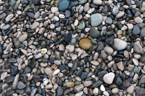 Small dark pebbles in the surf zone of the Black Sea.