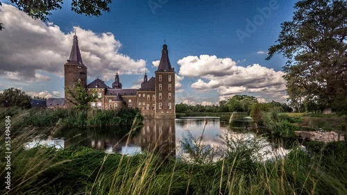 Hoensbroek Castle in the province of Limburg, The Netherlands. Time lapse footage with moving clouds, swans and geese swimming in the pond surrounding the castle. photo